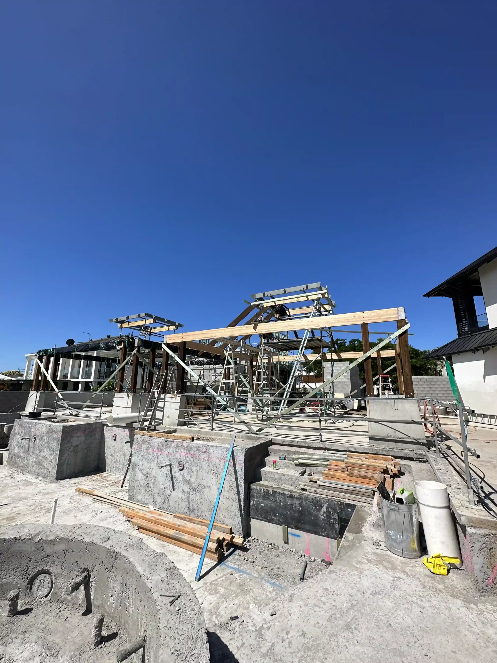 A custom Gold Coast home under construction, structural framing and scaffolding in place